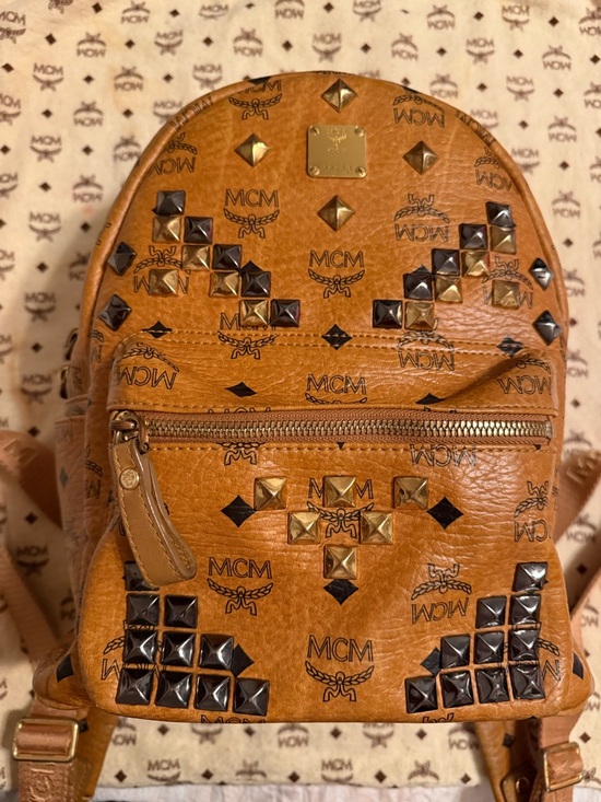 MCM Handbags - MCM Cognac Visetos Mini Backpack with Gold and Black Studs